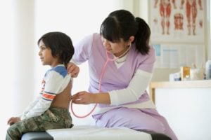 Medical Assistant Listens To Child's Breathing