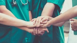Nurses put hands together 