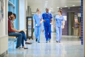 Nurses chatting in hospital hallway 
